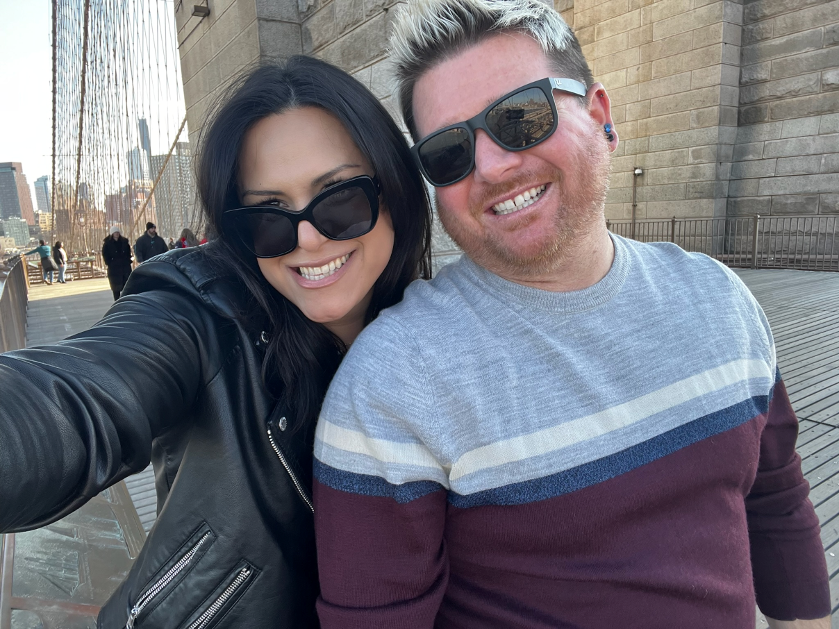 Brandon and Luna on a bridge in New York City